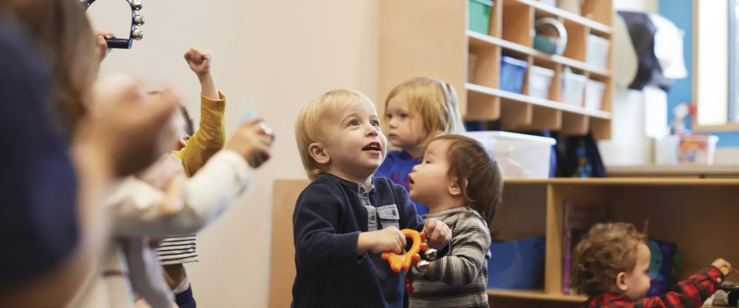 Toddlers standing in classroom