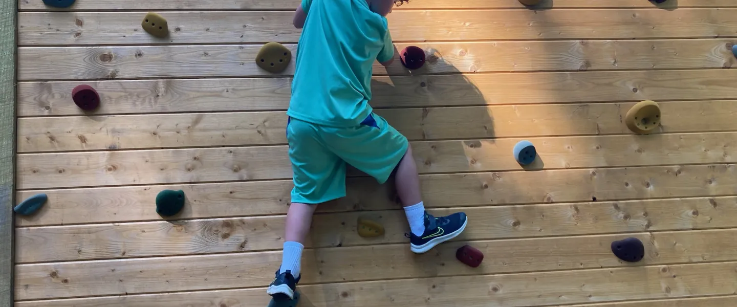 Boy climbing on Traverse Wall