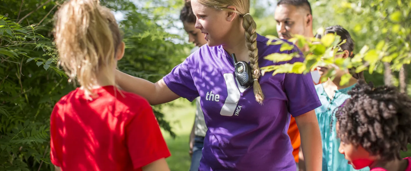 Female counselor showing campers nature