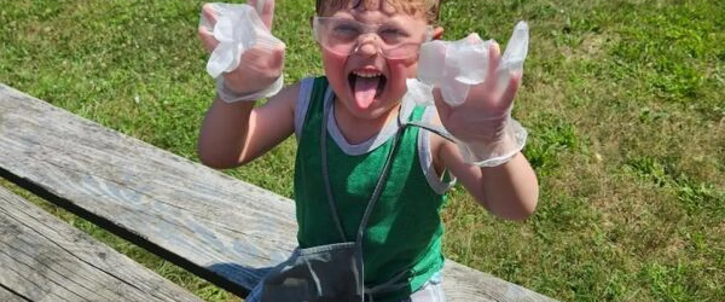 Boy doing a science experiment on a picnic table