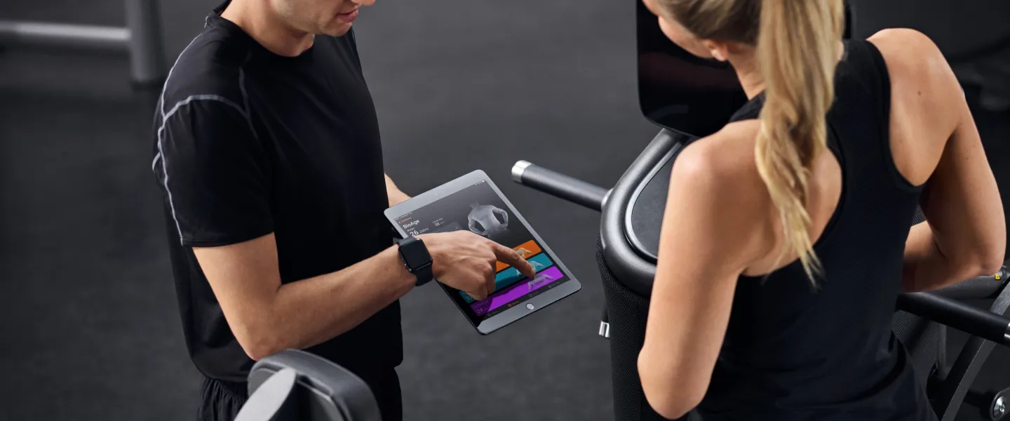Trainer showing client a tablet