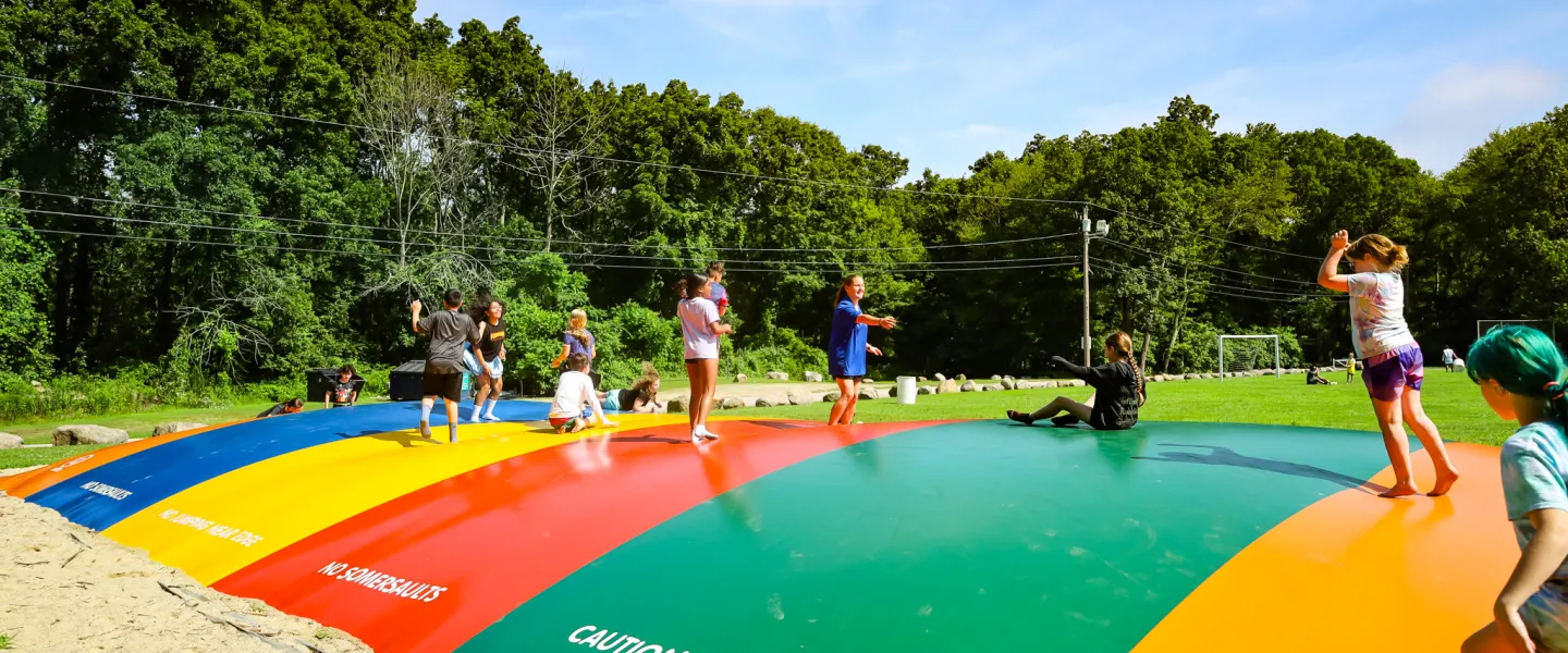 Kids Jumping on A Bounce House at Summer Camp