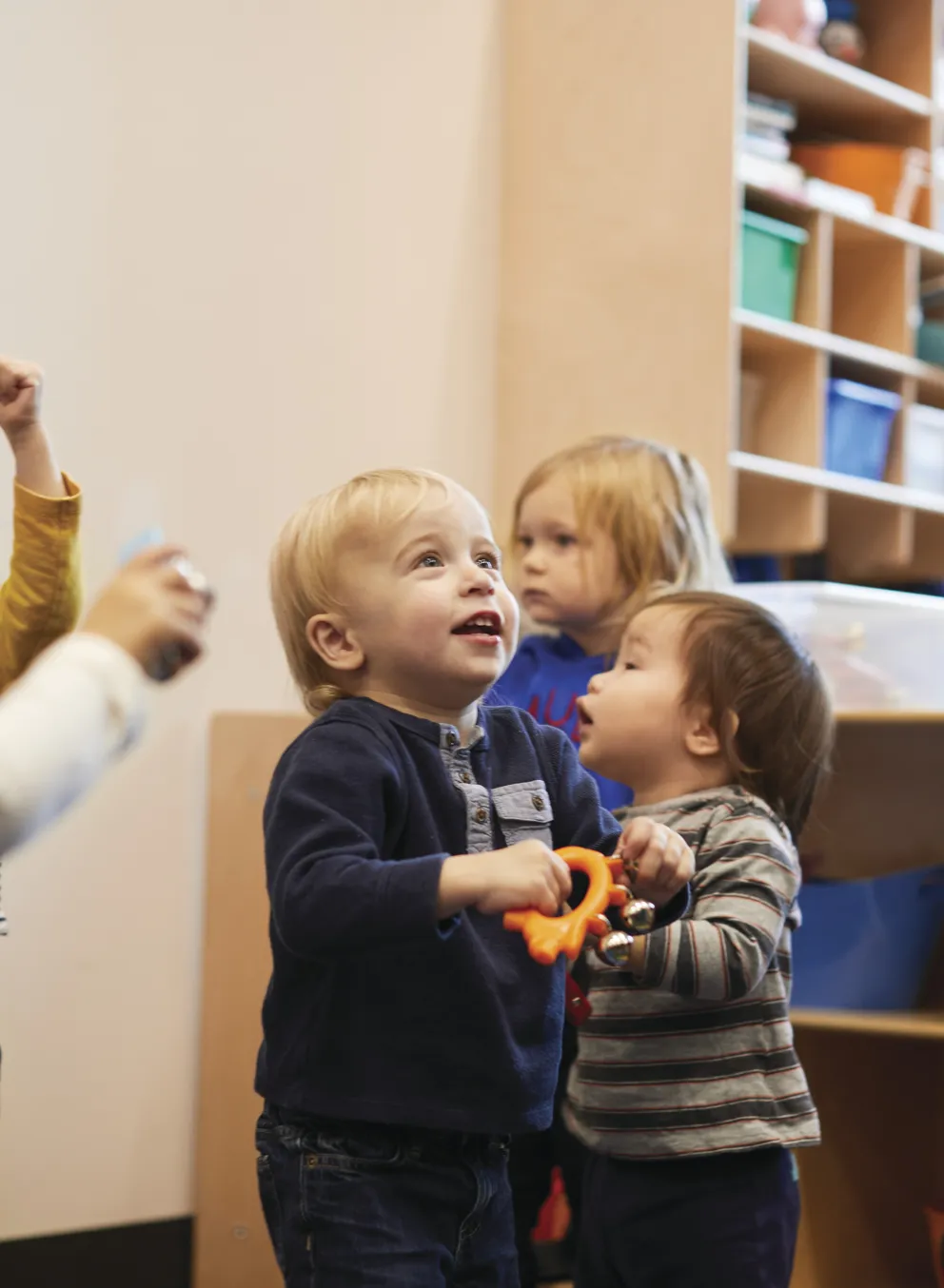 Toddlers standing in classroom