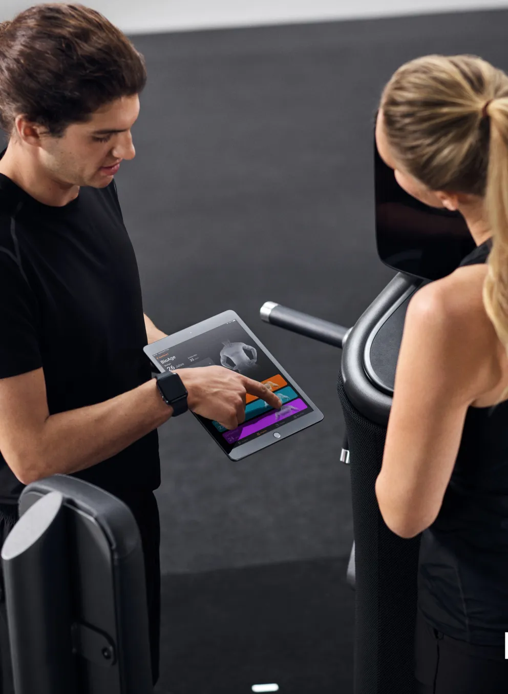 Trainer showing client a tablet