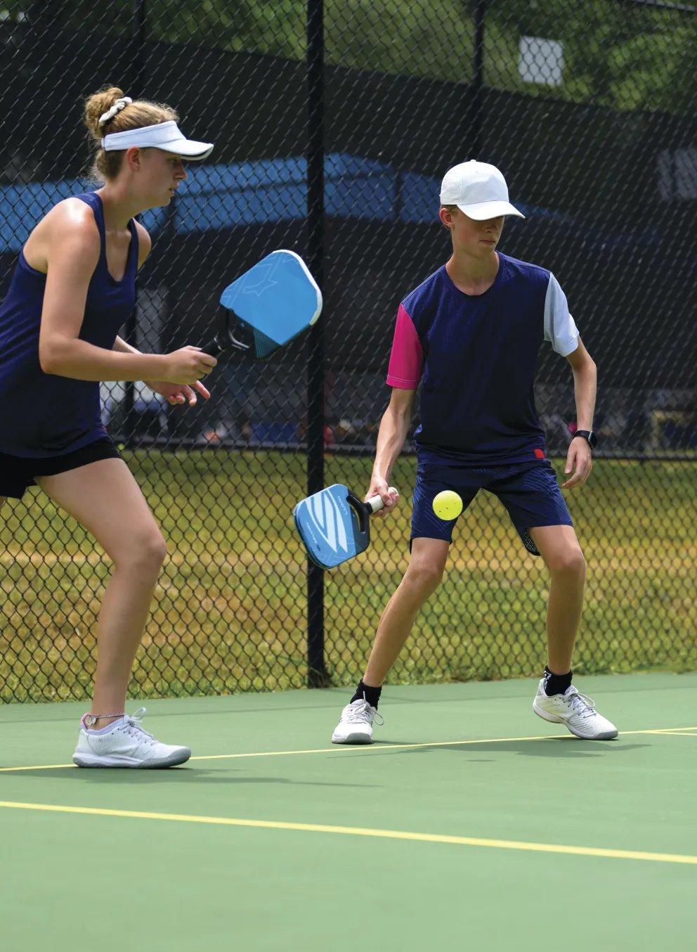 Woman and boy playing pickleball