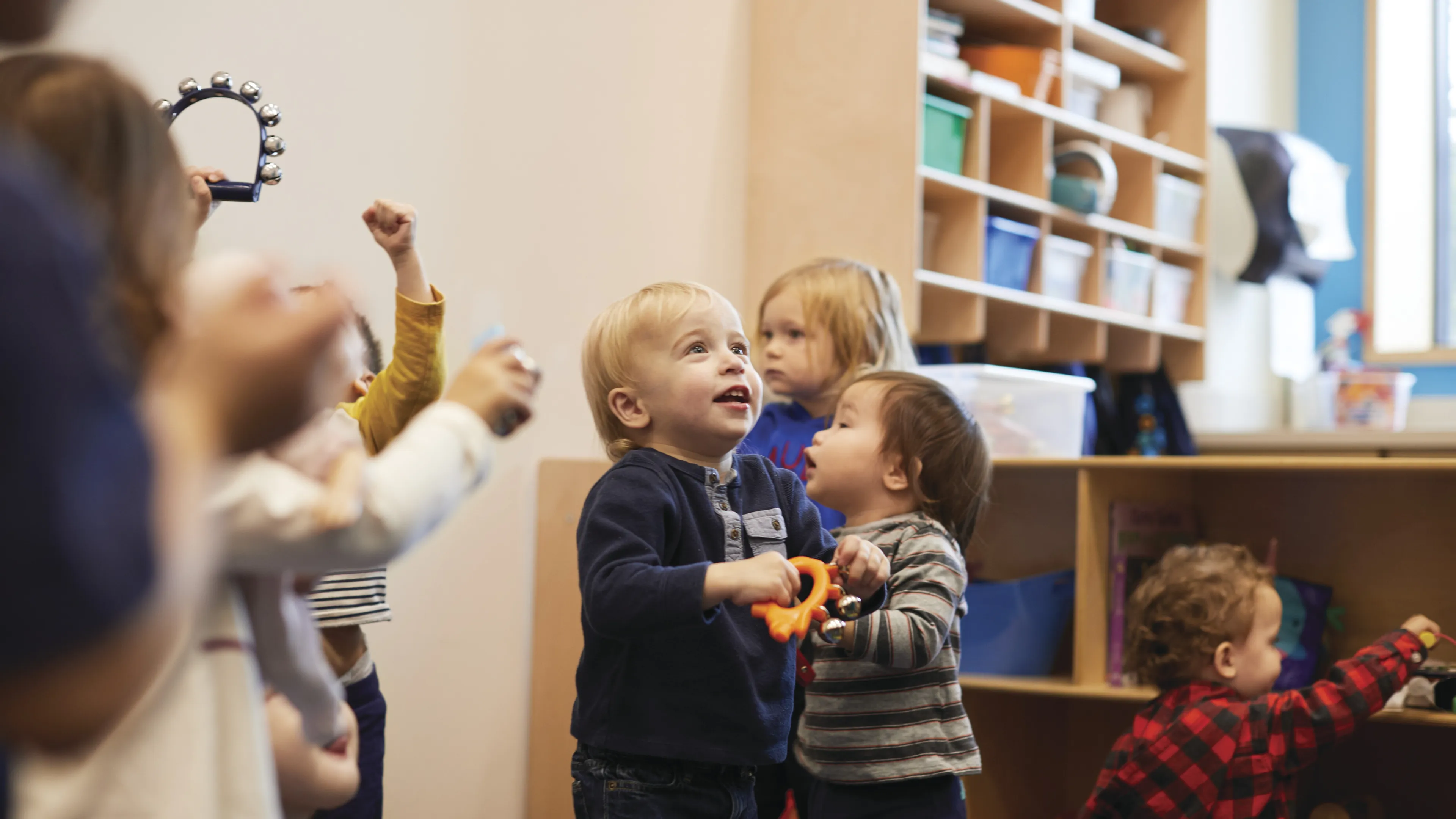 Toddlers standing in classroom