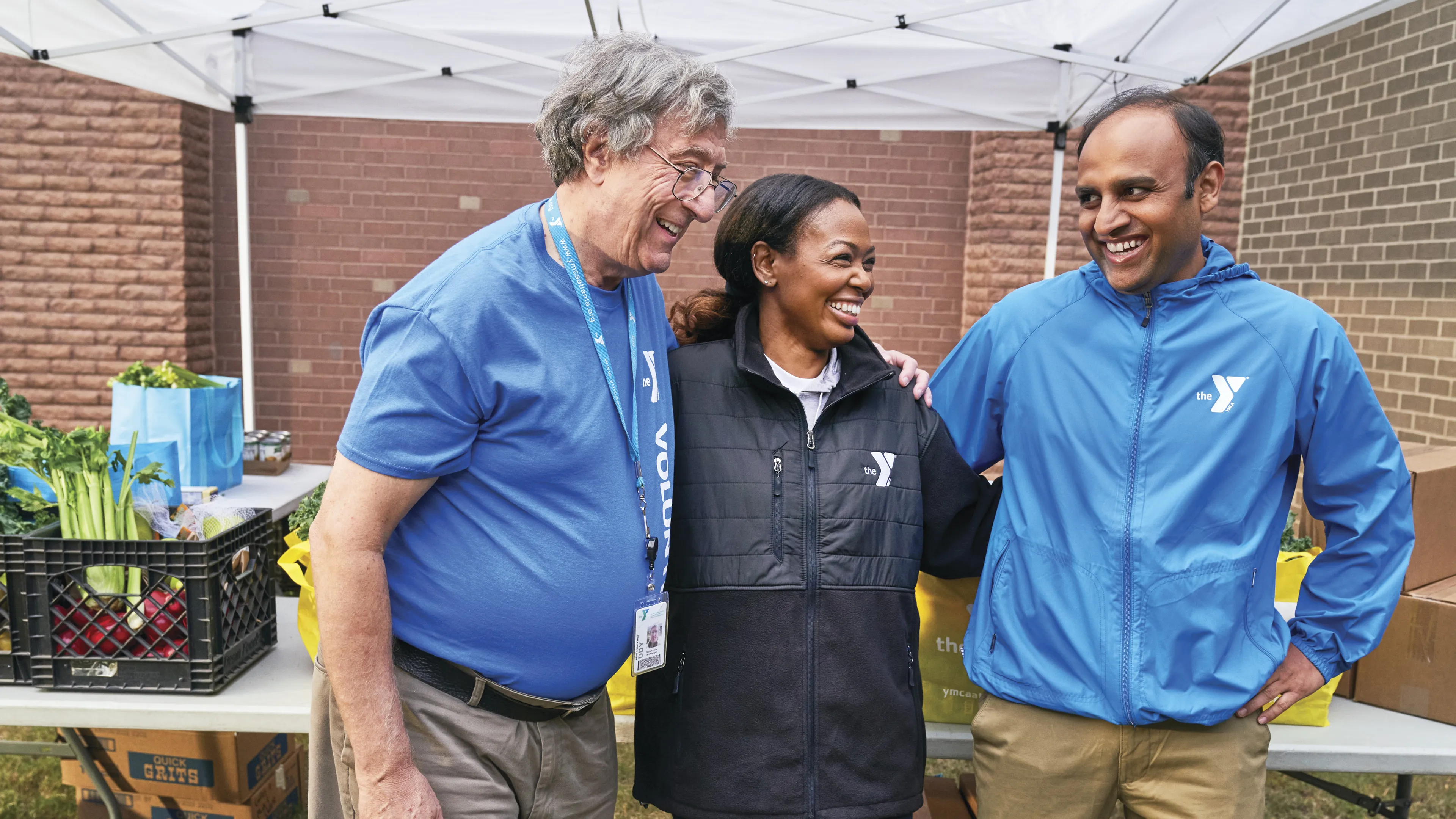 Two staff and a volunteer standing together
