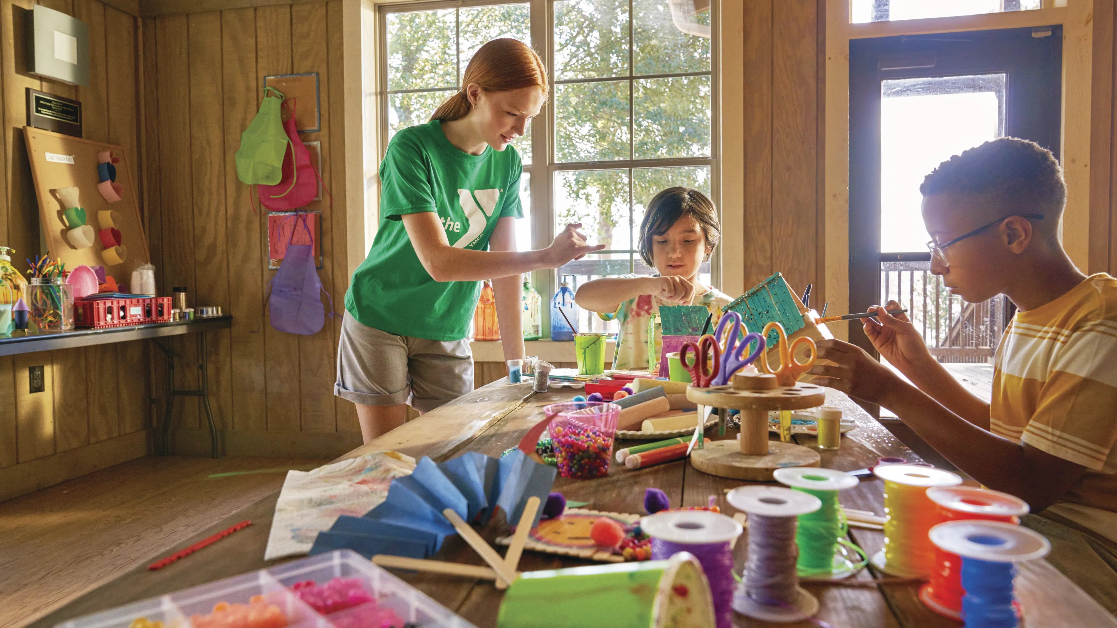 Two kids taking an art class with an instructor.