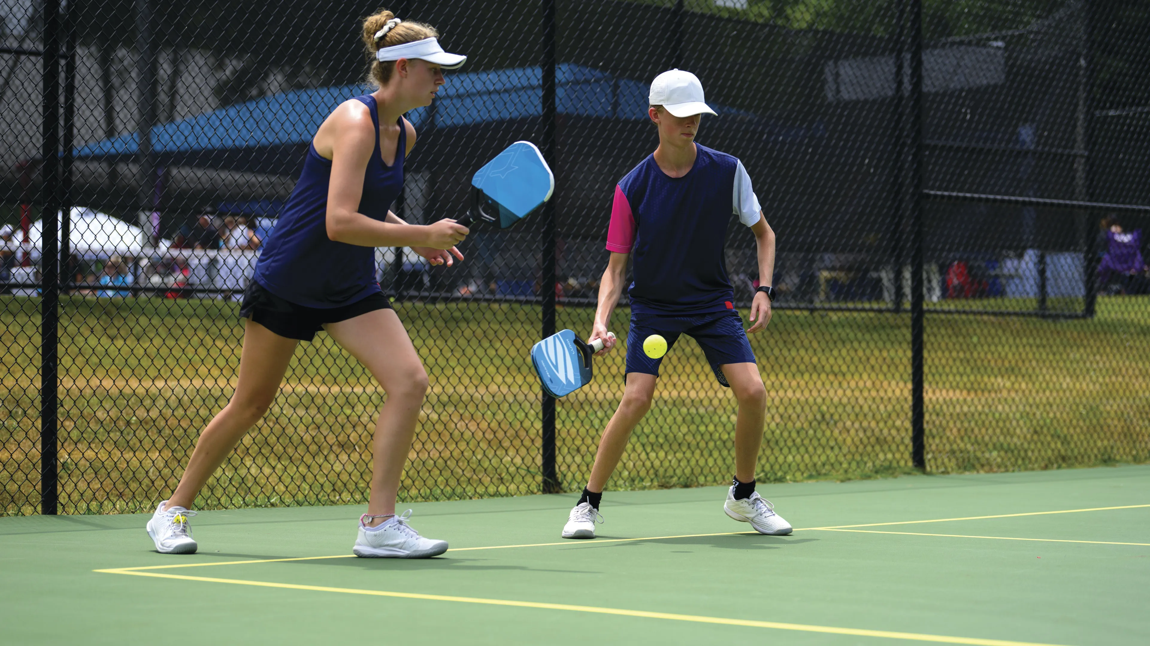 Woman and boy playing pickleball