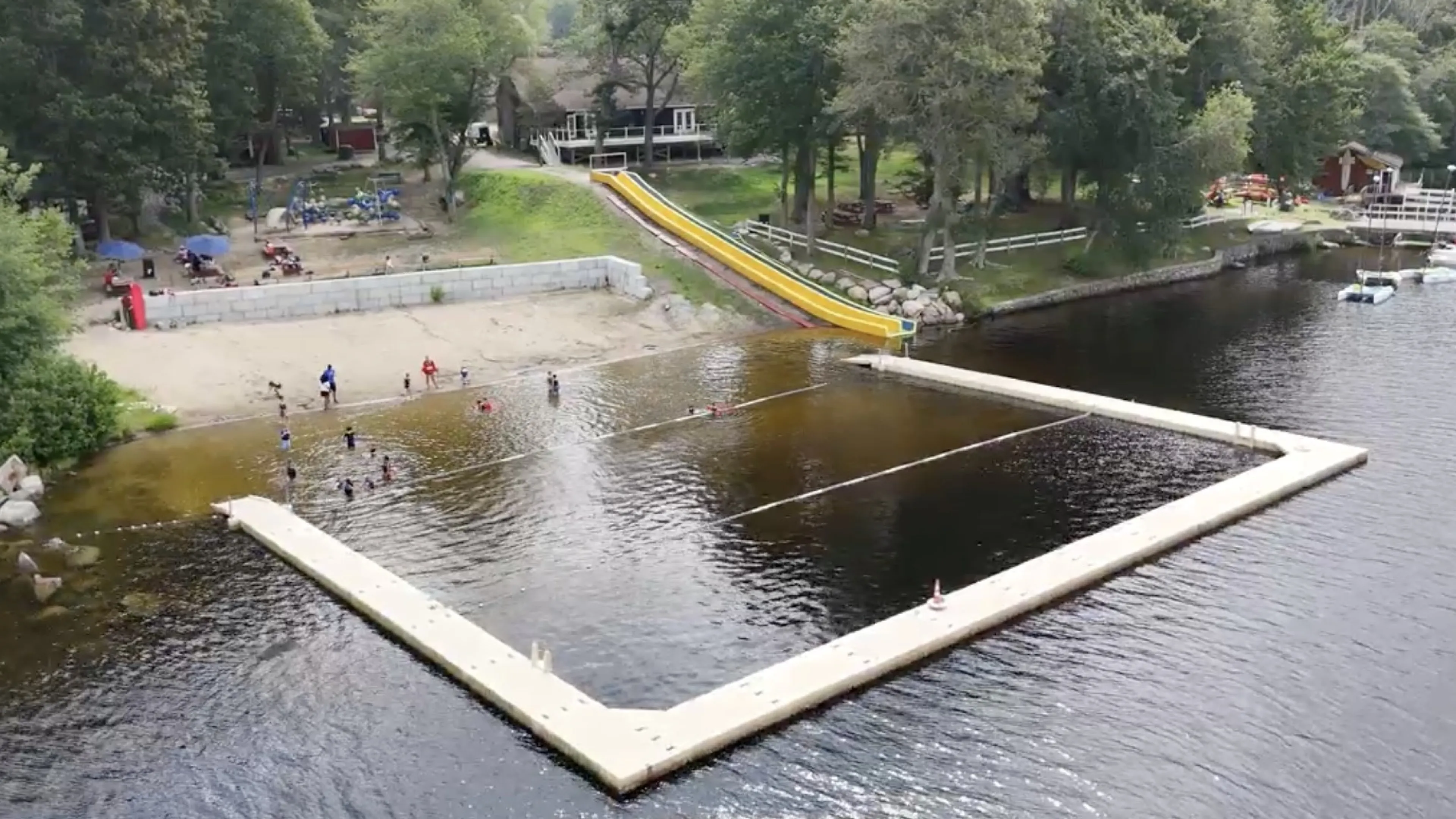 Waterfront with docks, sand, and a waterslide
