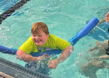 Boy with down syndrome swimming