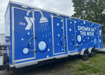 Blue trailer that says &quot;Shower on the Move&quot; with bubbles.