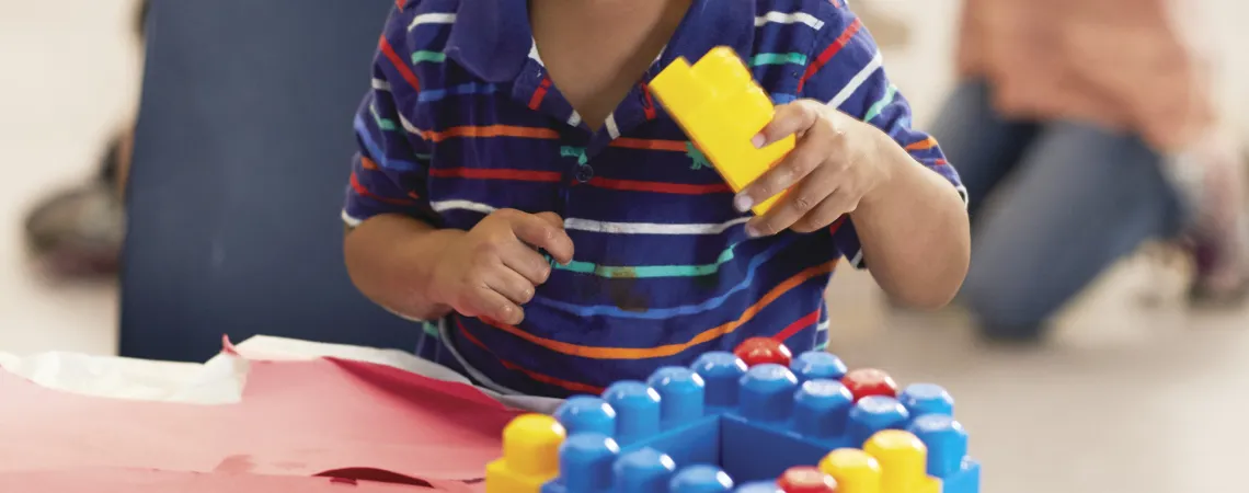 Toddler boy stacking blocks