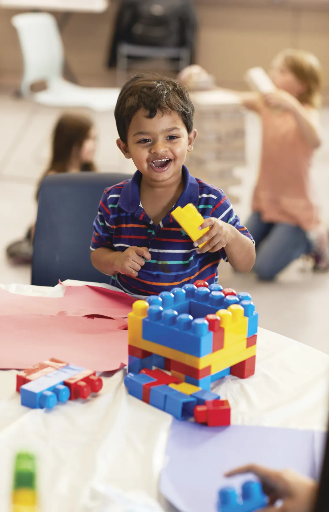 Toddler boy stacking blocks