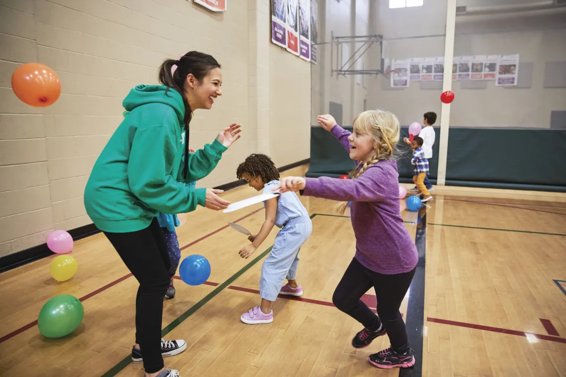 Kids playing with balloons during a birthday party