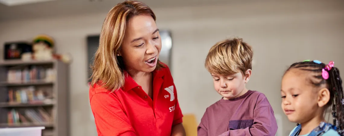 Female staff working with 2 kids