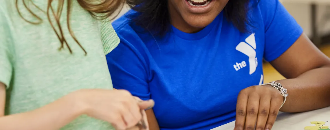 Female staff doing an art project with a girl
