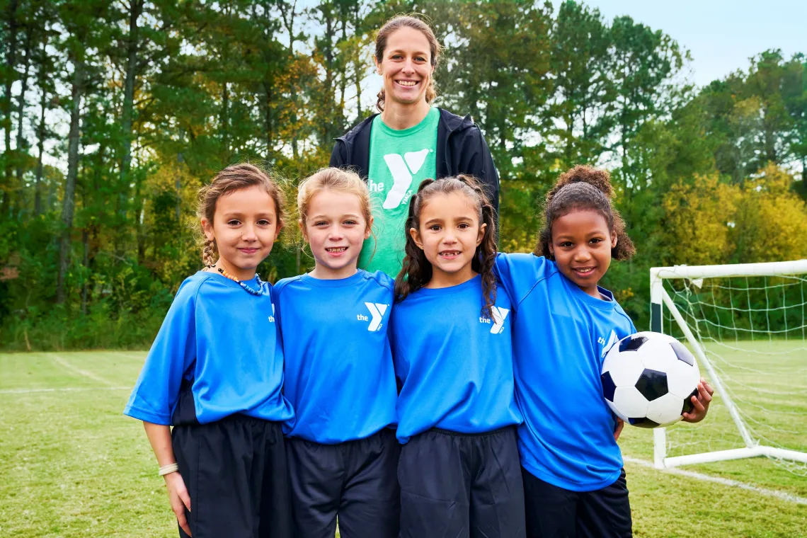 Female soccer coach with four girls