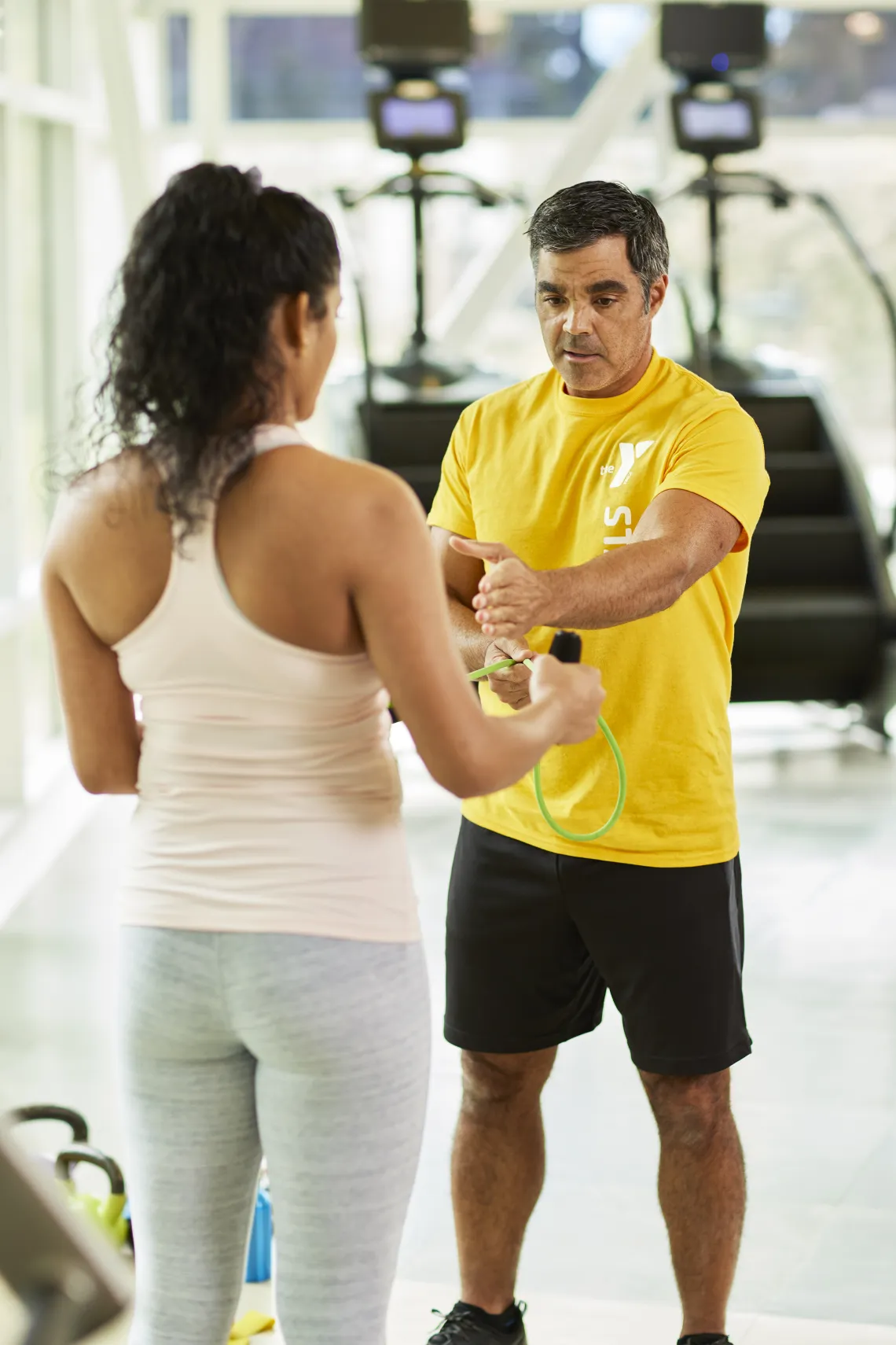 Male trainer working with female client