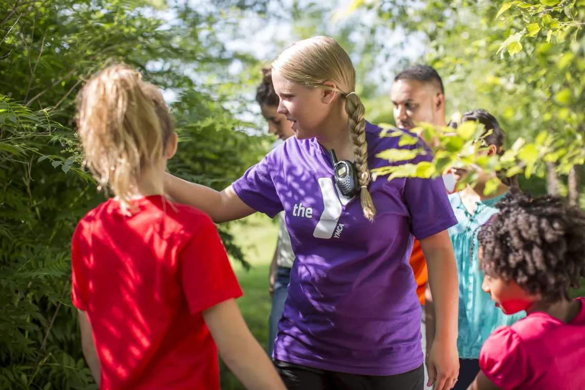 Female counselor showing campers nature