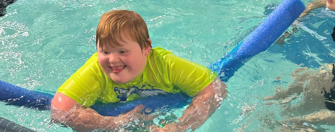Boy with down syndrome swimming
