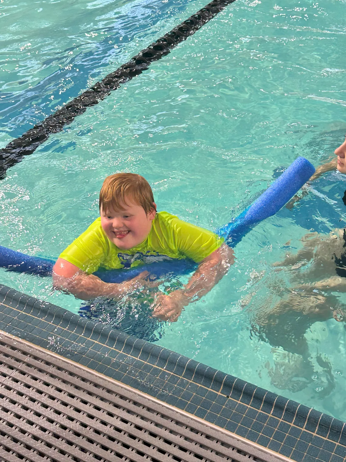 Boy with down syndrome swimming