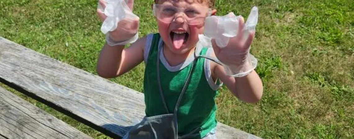 Boy doing a science experiment on a picnic table