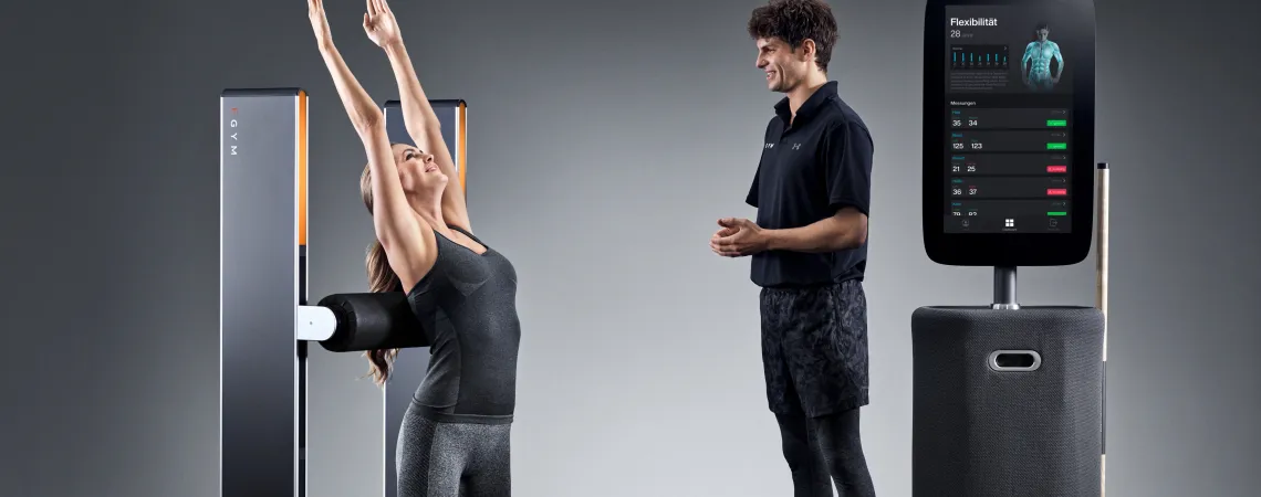 Trainer helping client with a machine