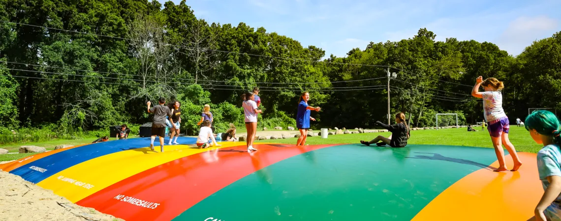 Kids Jumping on A Bounce House at Summer Camp