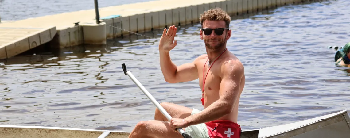 Summer Camp Counselor Life Guard Canoeing Smiling on a Lake