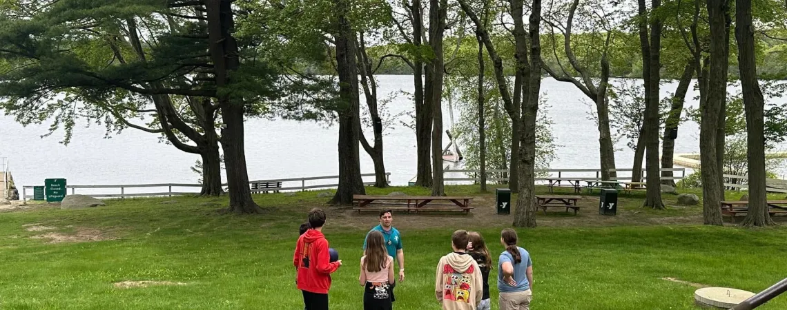 Camp Director giving 6 people a tour of the property down at the waterfront.